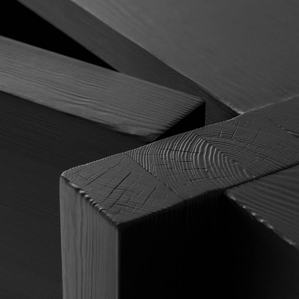 Macro detail of the Itooraba Sideboard Black by Sizar Alexis, emphasizing burned pine end grain, joinery marks and hand-finished texture.