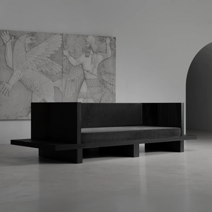 Three-quarter view of the Itooraba Sofa by Sizar Alexis, featuring dark upholstery, a black pine frame and extended side platforms.