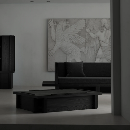 Front view of the Itooraba Sofa by Sizar Alexis displayed behind a matching coffee table in a monochromatic architectural interior.