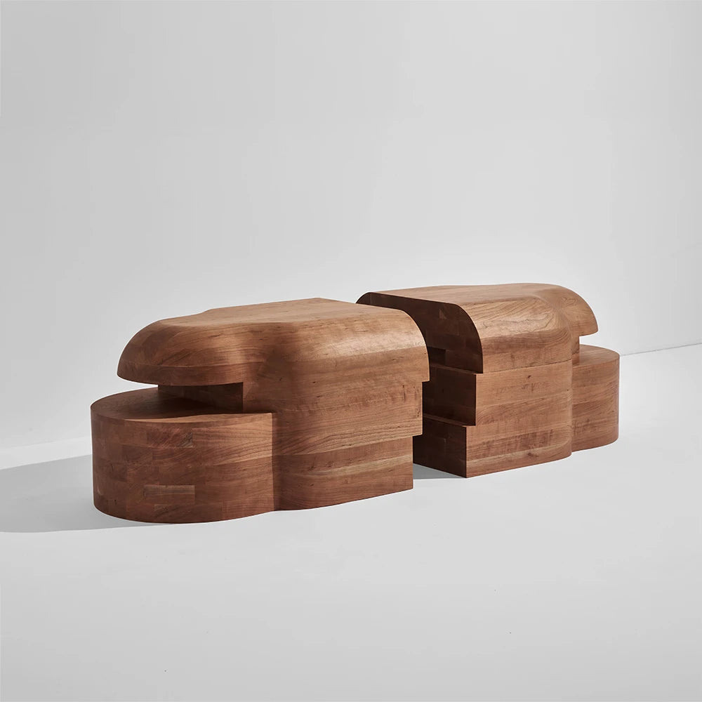 Three-quarter view of the separated Lahmu Large Console Natural by Sizar Alexis, highlighting its interlocking forms and warm wood grain.