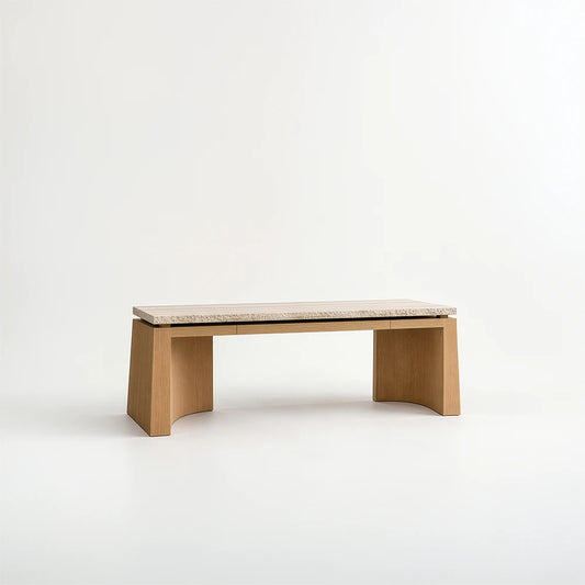 Santos Desk by Studio Romell, featuring a pale stone top with a textured edge, flush drawer fronts and wooden supports with curved inner surfaces.