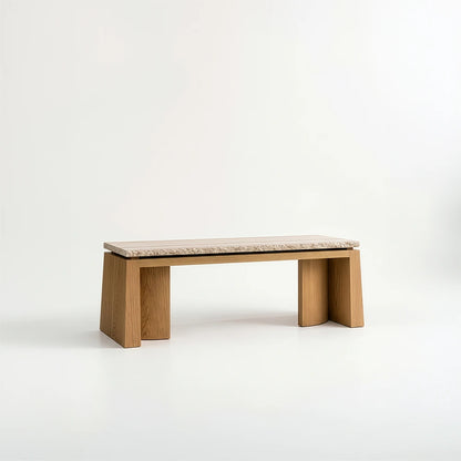 Rear three-quarter view of the Santos Desk by Studio Romell, showing its rectangular stone top, warm wooden frame and broad sculptural side supports.