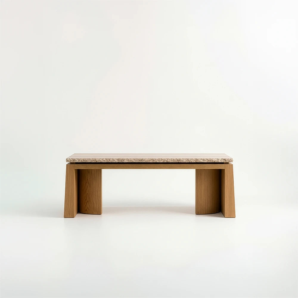 Rear view of the Santos Desk by Studio Romell, featuring a continuous wooden rail beneath the stone top and two broad supports framing the open centre.